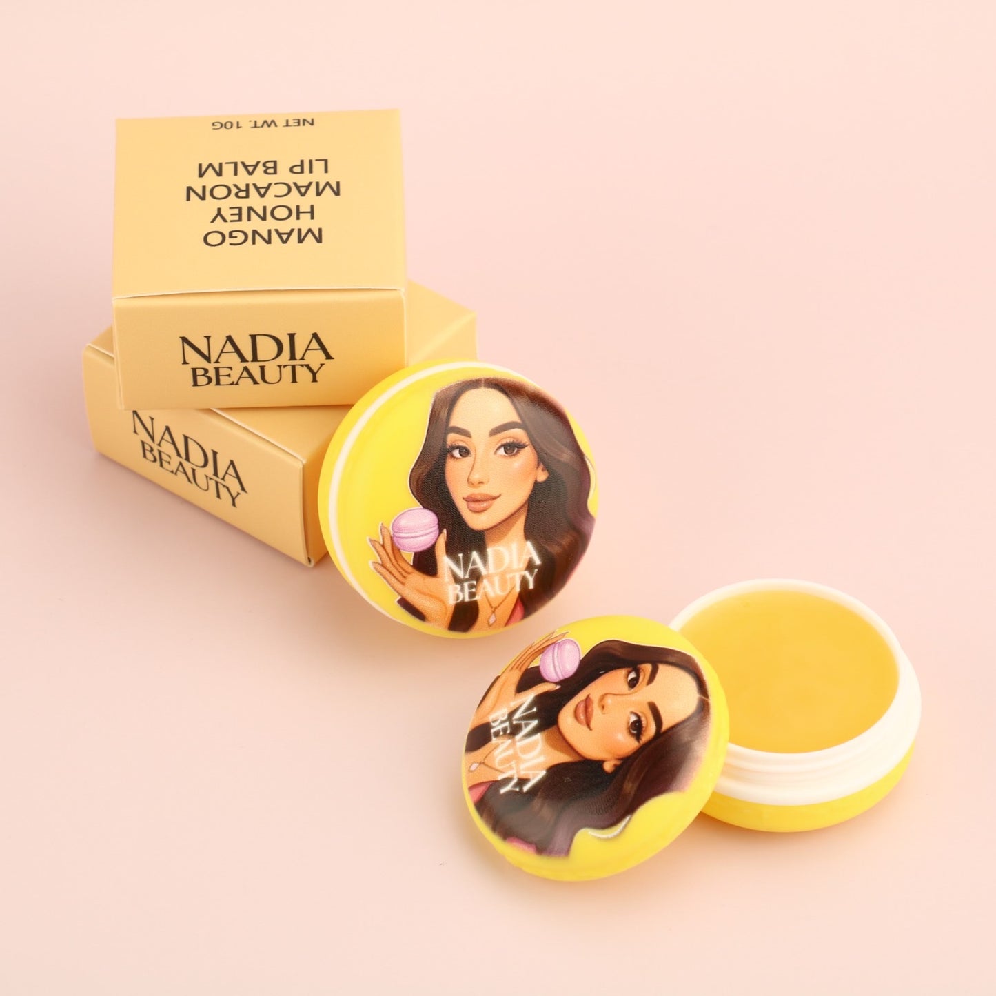 Nadia Beauty lip balm with packaging on a beige background