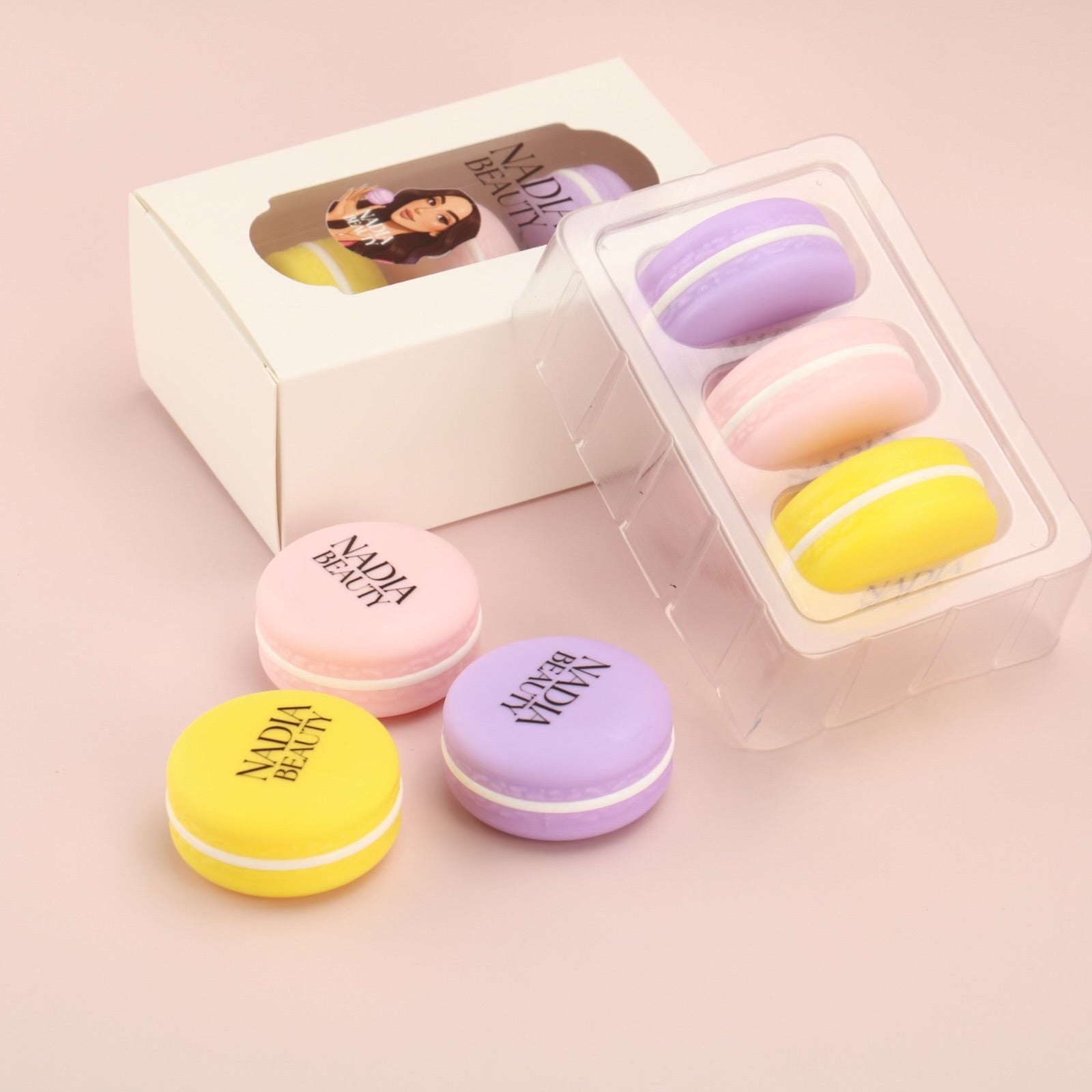 Colorful macaron-shaped containers with 'Nadia Beauty' branding on a pink background
